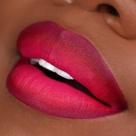 The Lip Bar minis beside a coin to show travel-size convenience and portability
