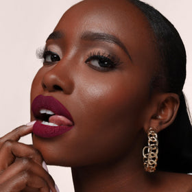 The Lip Bar Muse with jojoba seeds highlighting nourishing jojoba oil for softer lips