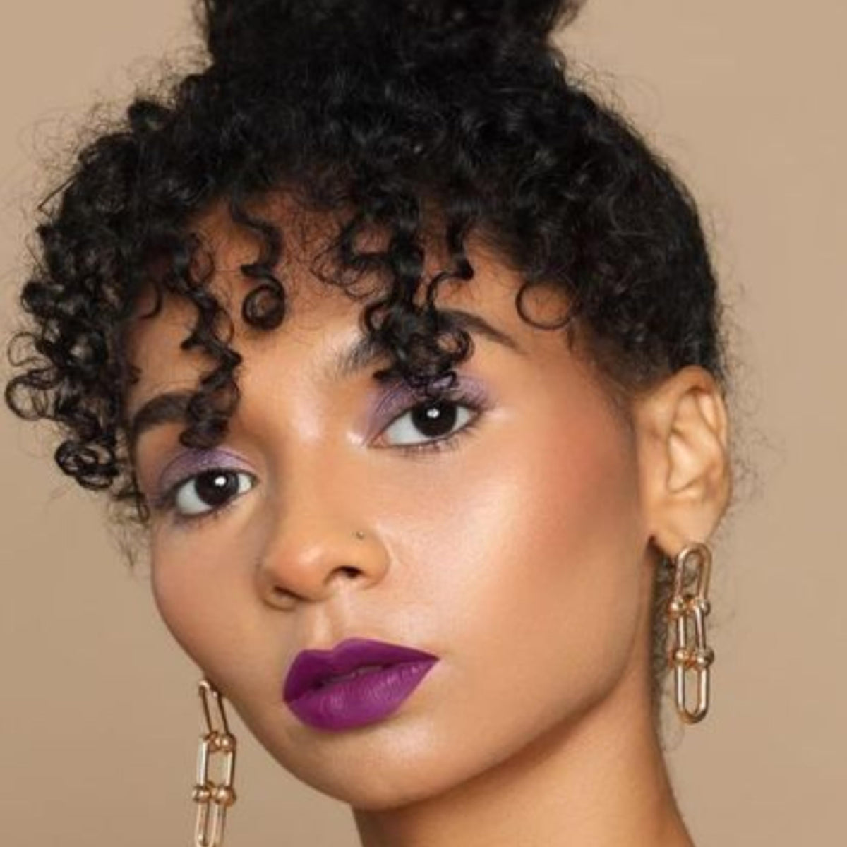 The Lip Bar Prima Donna next to a ruler showing .24 fl oz compact travel size