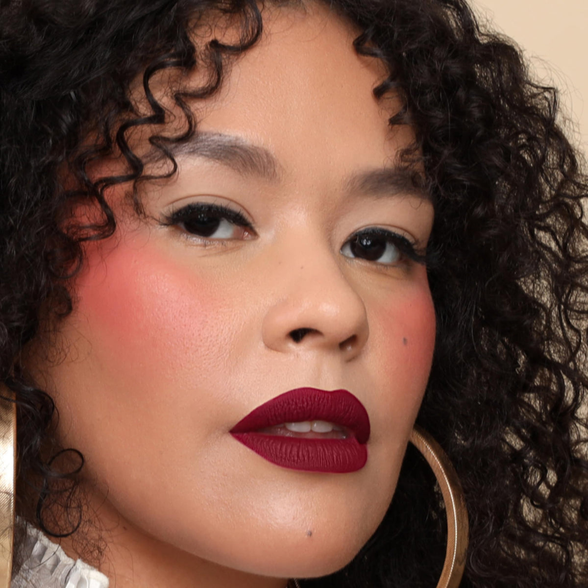 The Lip Bar Rebel deep burgundy tube closed showing rich pigment benefit