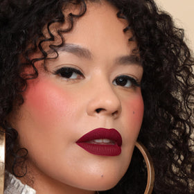 The Lip Bar Rebel deep burgundy tube closed showing rich pigment benefit