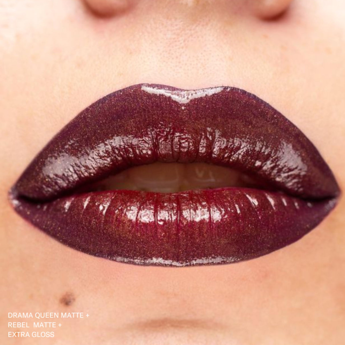 The Lip Bar Rebel ingredients label closeup shows jojoba oil and vitamin E benefit