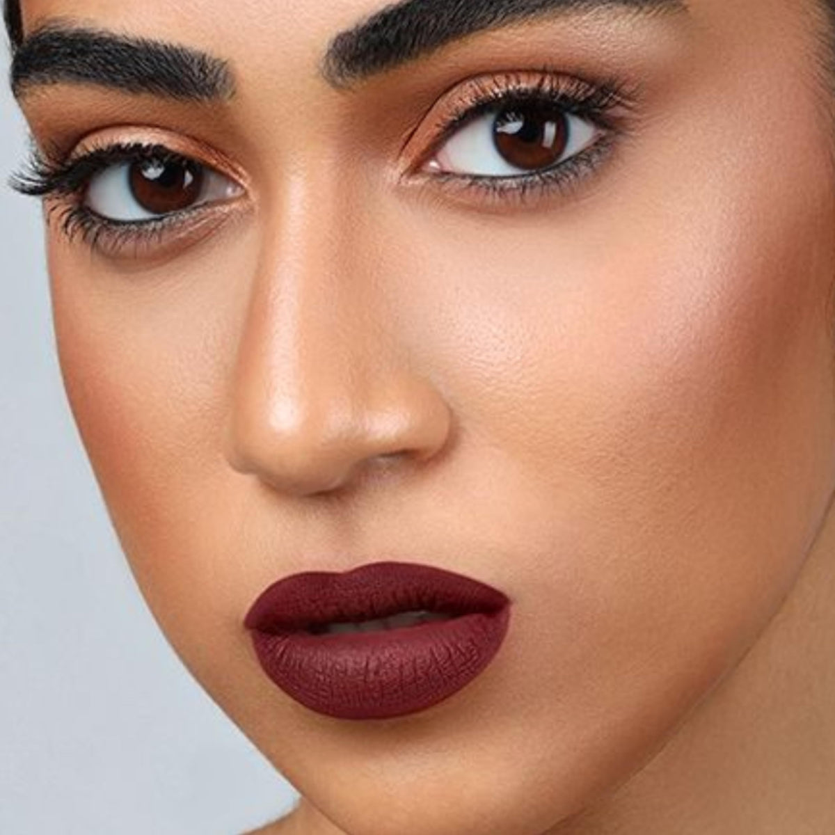 The Lip Bar Rebel on model in evening lighting shows bold long-wear impact