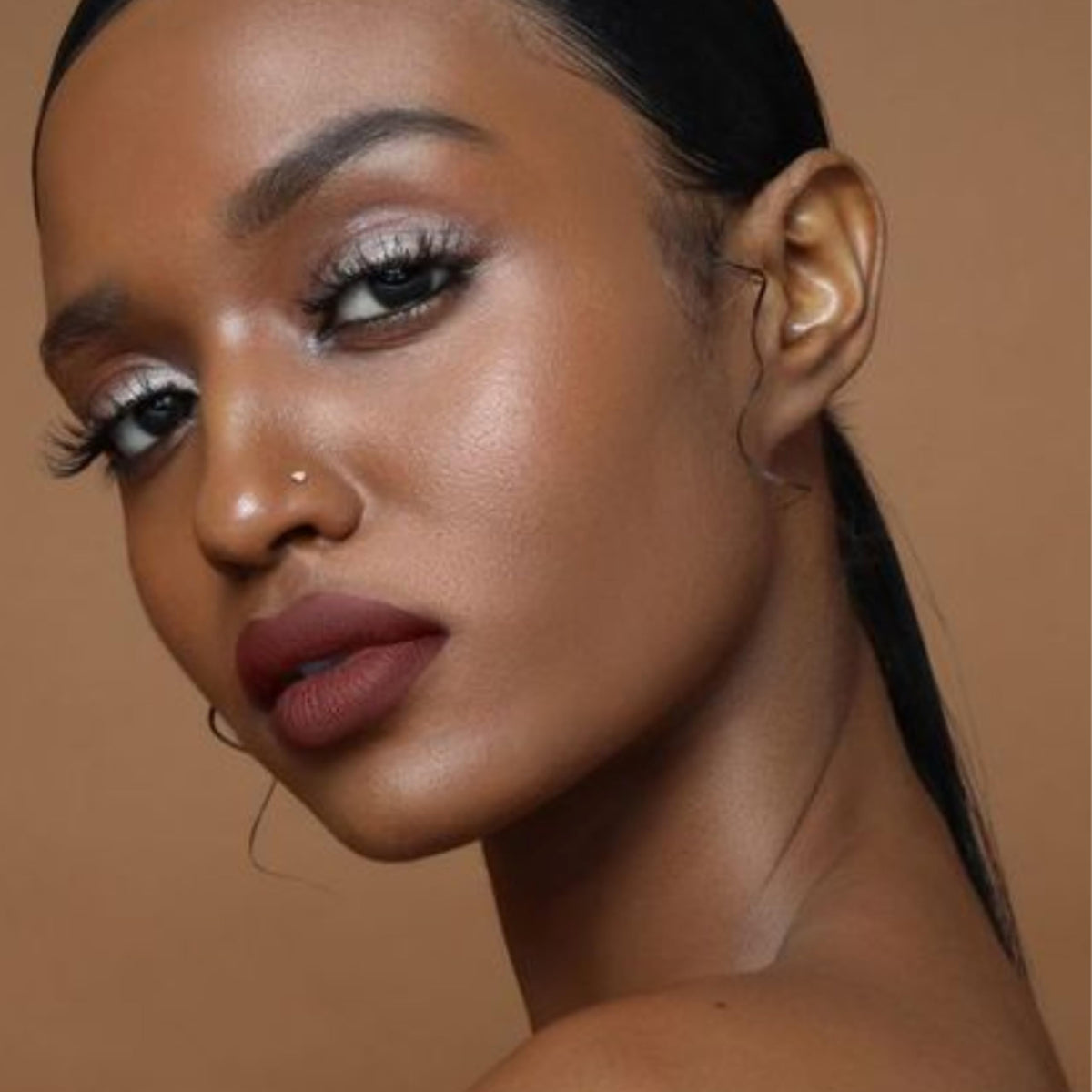 The Lip Bar Savage tube next to common items showing .24 fl oz size convenience
