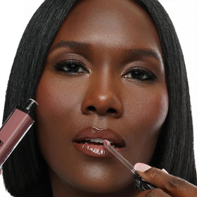 The Lip Bar gloss texture close-up with champagne shimmer showing luminous finish