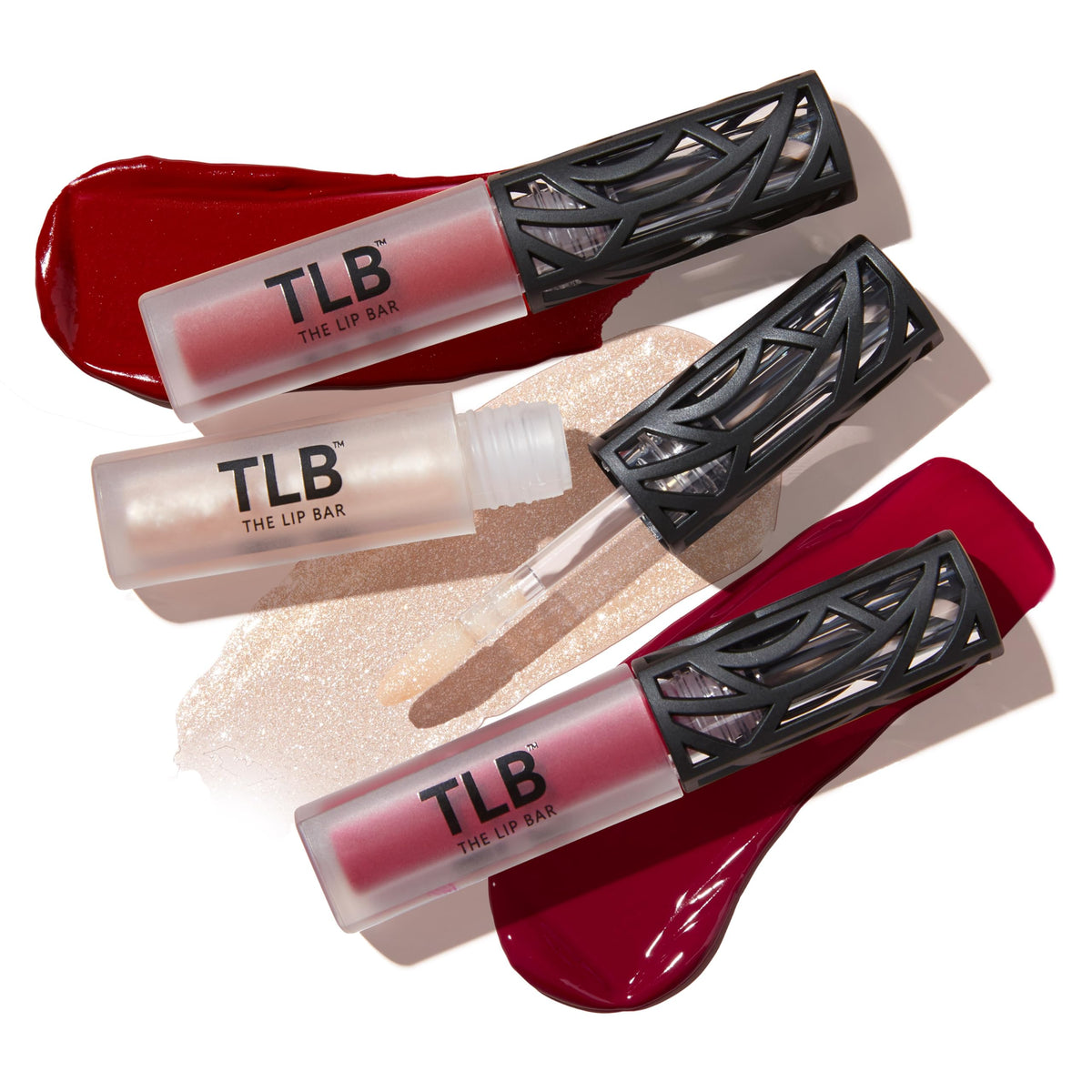 The Lip Bar Trophy Wife gloss swatch on skin showing shimmer and shine