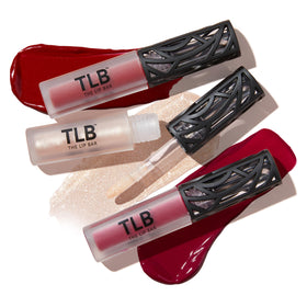 The Lip Bar Trophy Wife gloss swatch on skin showing shimmer and shine