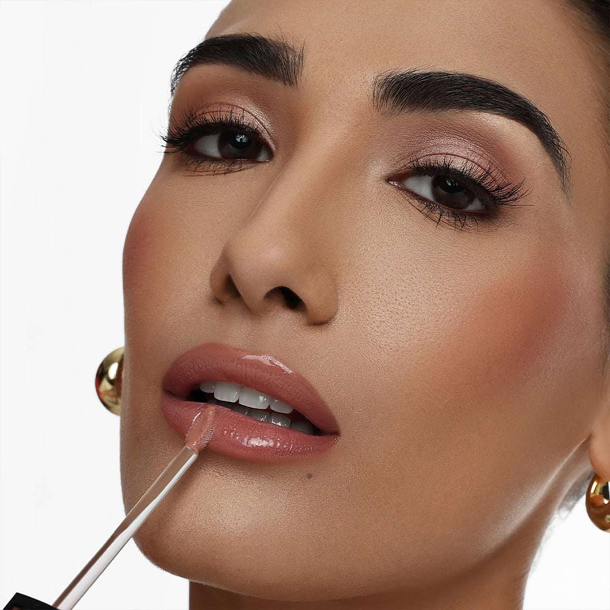 The Lip Bar gloss layered over a liquid matte demonstrating added shine