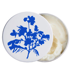 the outset tin front view showing compact balm for travel convenience