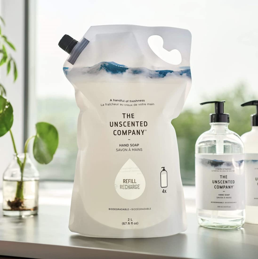 The Unscented Company refill spout closeup illustrating easy pour and reduced waste