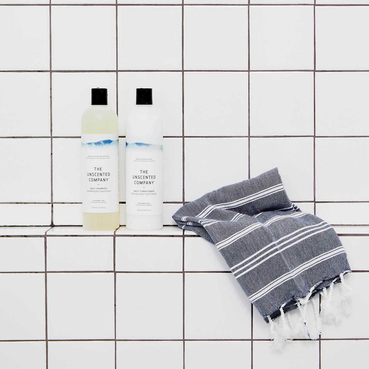 Shampoo bottle on bathroom shelf in use scene by The Unscented Company for natural look