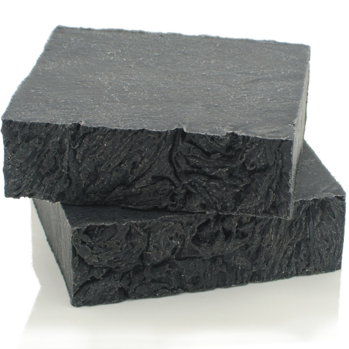 The Yellow Bird soap texture close-up highlighting charcoal marbling and natural ingredients benefit