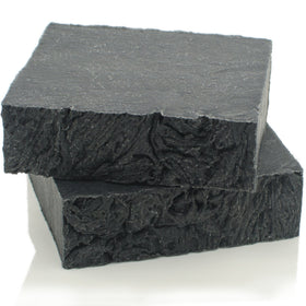 The Yellow Bird soap texture close-up highlighting charcoal marbling and natural ingredients benefit