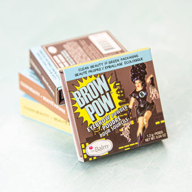 theBalm compact held in hand showing travel-friendly size and portability benefit