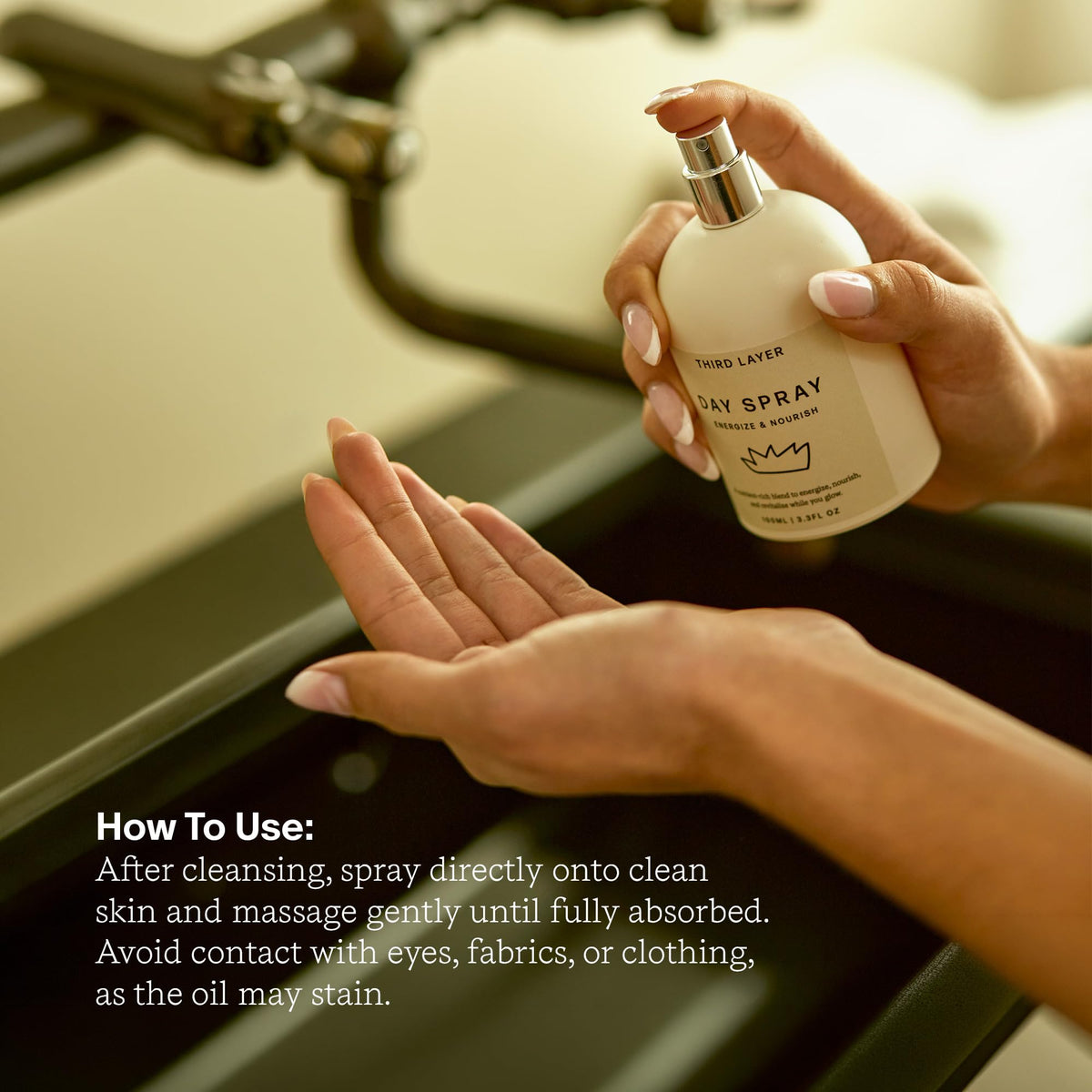 Third Layer bottle held in hand for scale, helps visualize the compact 3.3 fl oz size
