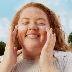 Three Ships applying cream to face during a morning skincare routine