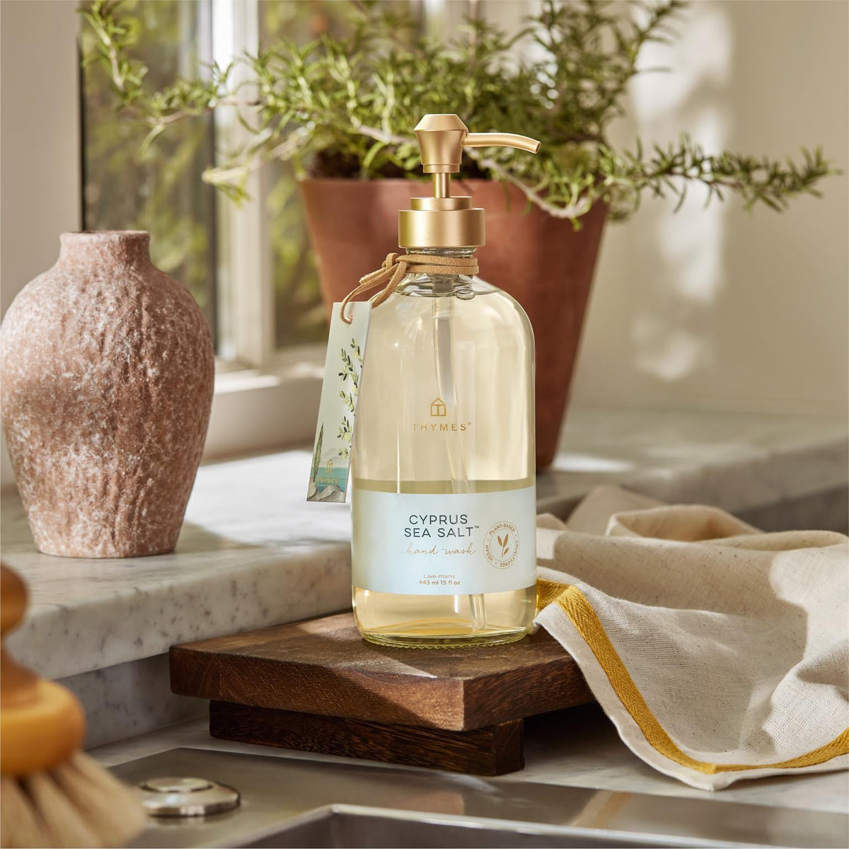 Thymes bottle on bathroom vanity creating a refined, fragrant hand-washing moment