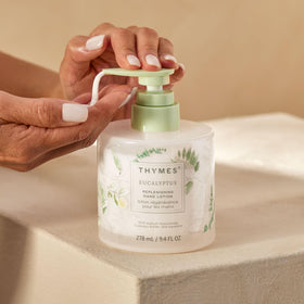 Thymes eucalyptus bottle beside matching hand wash for coordinated moisturizing routine benefit