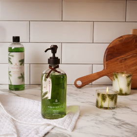 Thymes Frasier Fir next to a common bottle for scale showing 15 fl oz capacity