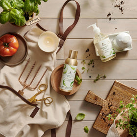 Thymes bottle next to hand for size comparison and countertop suitability