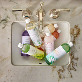 Thymes pouring refill into pump bottle demonstrating easy refill benefit