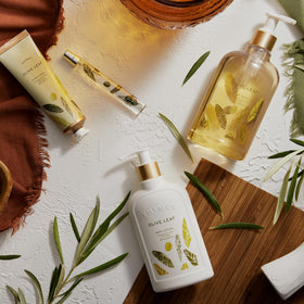 Thymes pouring body wash into hand demonstrating rich lather and cleansing benefit