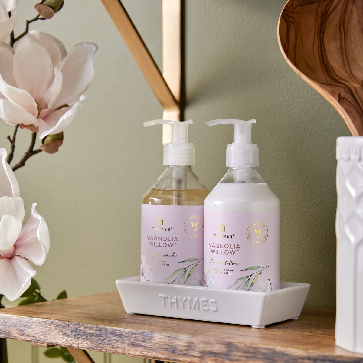 Thymes bottle beside a hand for scale showing generous 9 fl oz size