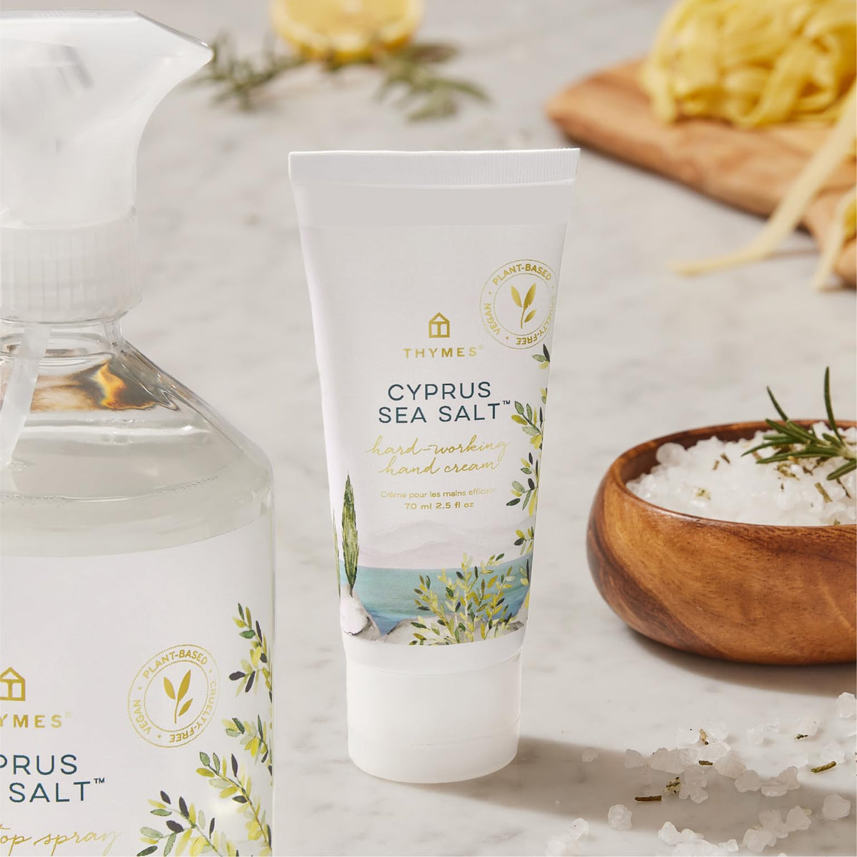 Thymes travel size tube next to smartphone showing scale and portability advantage