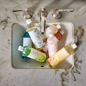Thymes bottle beside a hand for size comparison and practical benefit