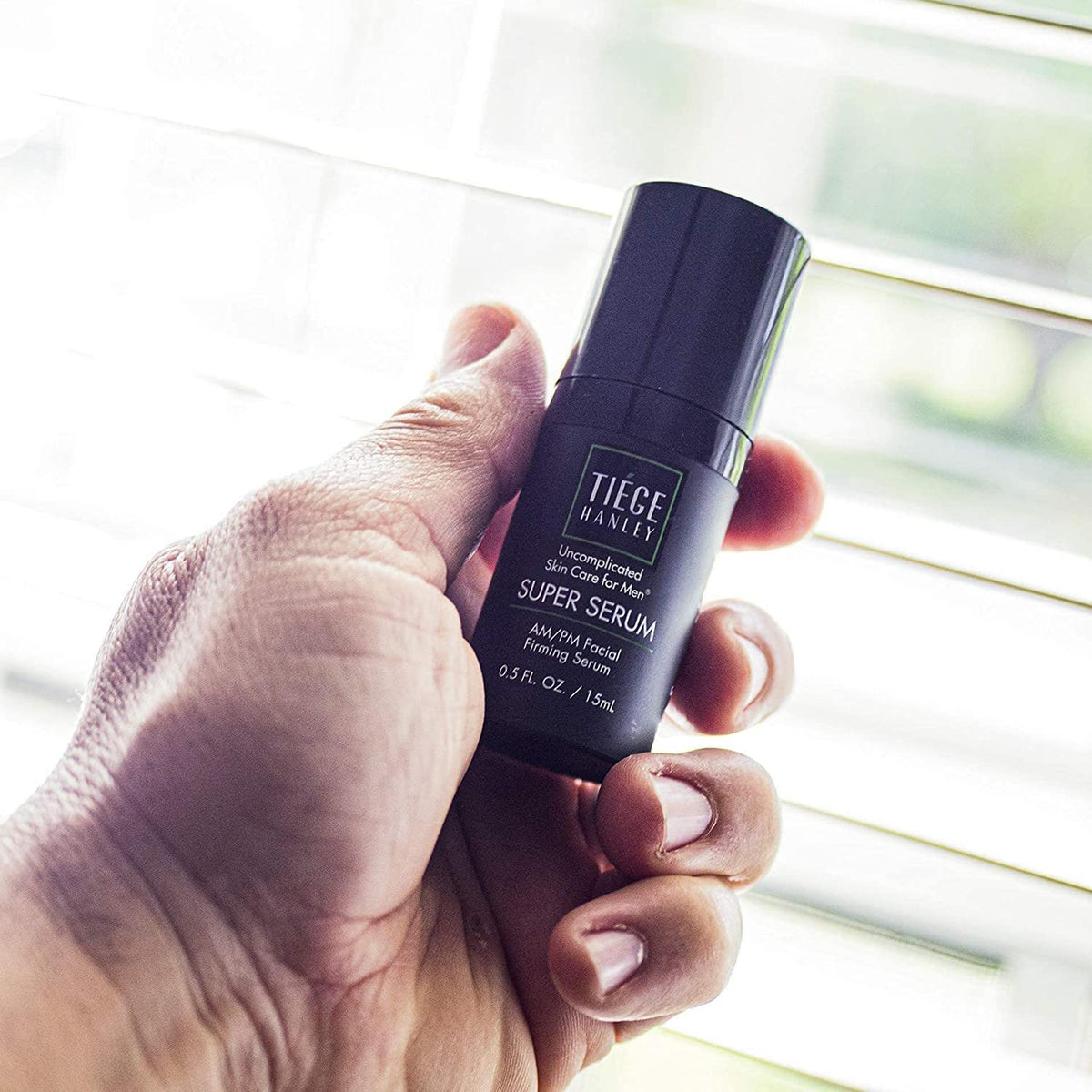 Tiege Hanley applying eye cream under-eye area demonstrating reduced puffiness benefit