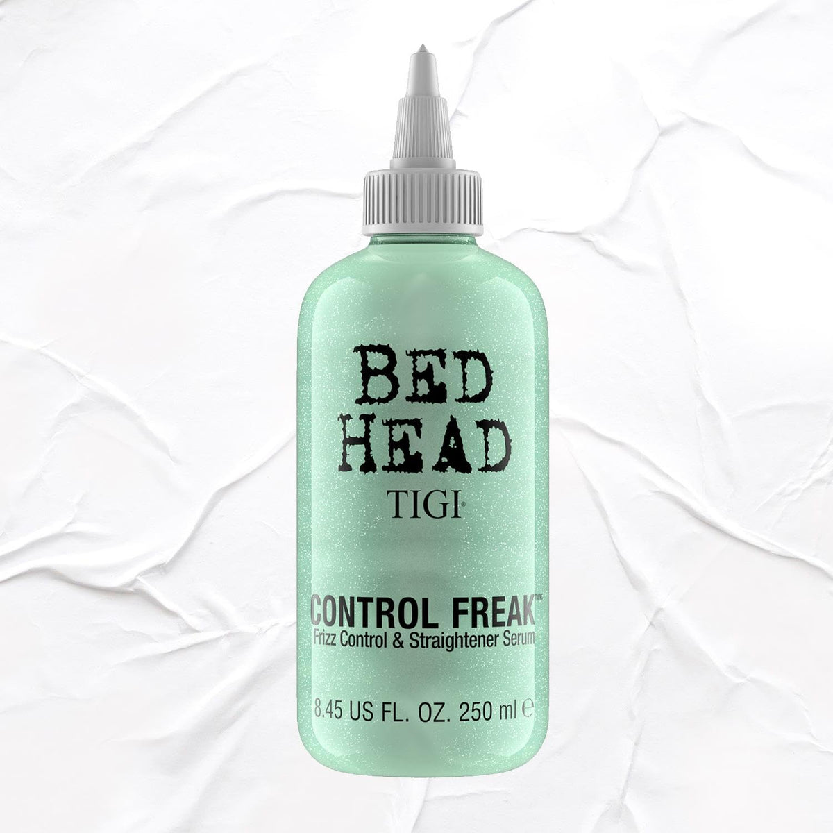 TIGI Bed Head bottle next to ruler showing 8.45 fl oz size for value
