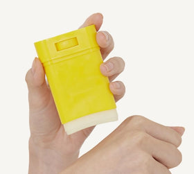 Tipiak sun stick in a beach setting showing on-the-go sun defense benefit