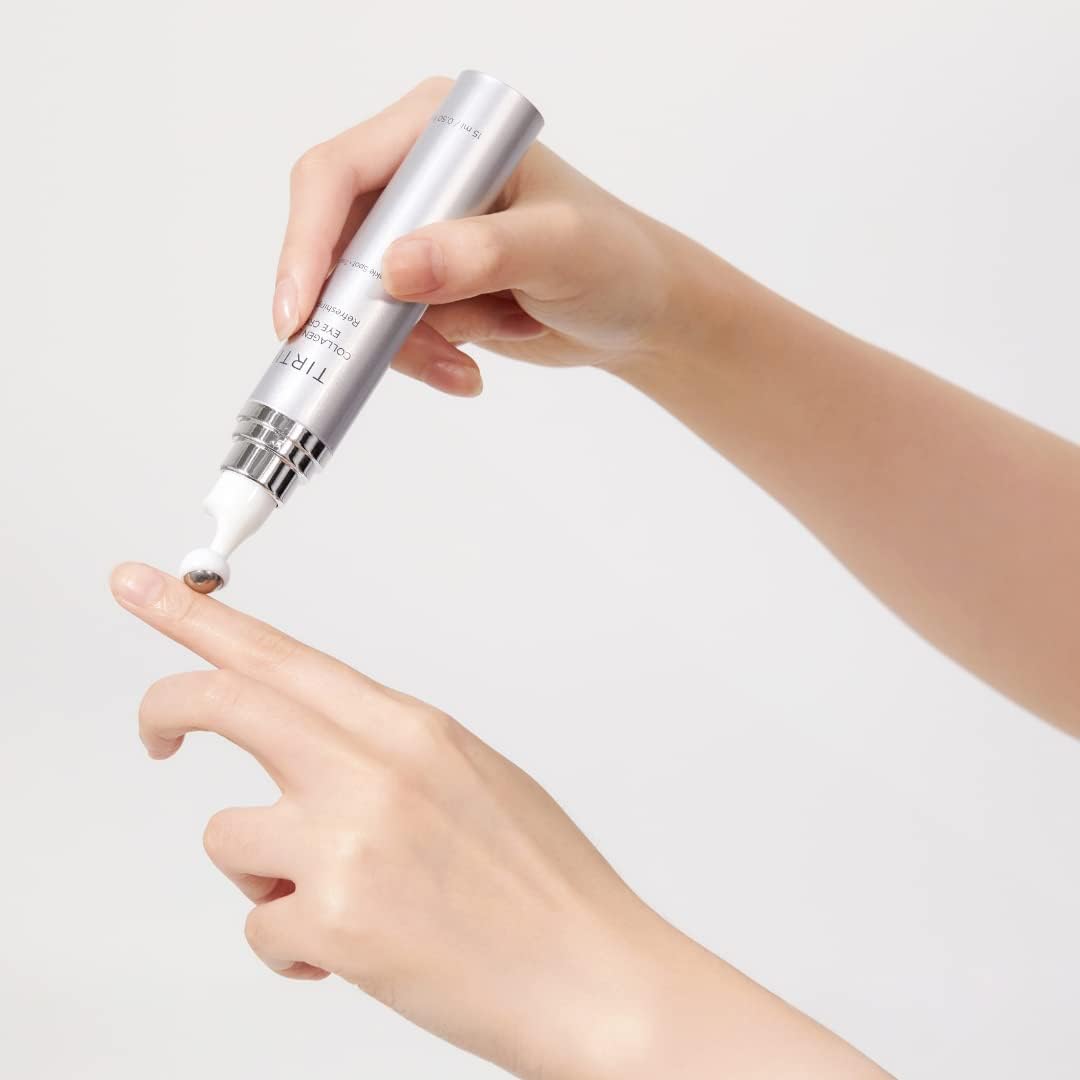 TIRTIR tube next to fingers for scale showing compact size and precise dispensing