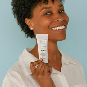 TIZO size comparison next to coin shows compact travel-friendly tube