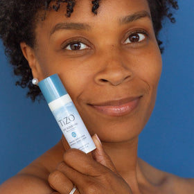 TIZO product being applied under eye demonstrating invisible finish benefit