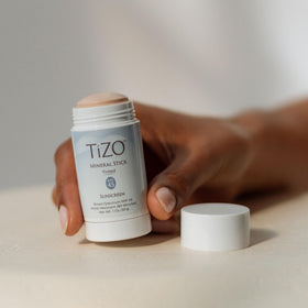 TIZO mineral stick in a beach bag showing water-resistant protection benefit
