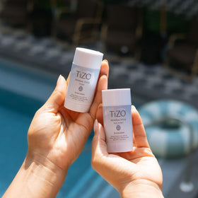 TIZO mineral stick on a beach towel in lifestyle scene highlighting water resistant benefit