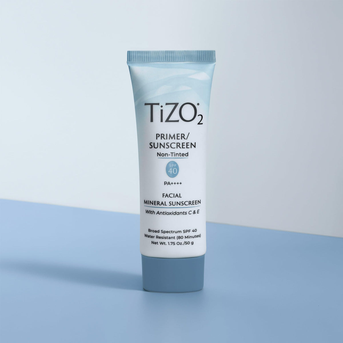 TIZO tube next to ruler showing 1.75 oz scale for size and travel convenience