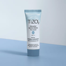 TIZO tube next to ruler showing 1.75 oz scale for size and travel convenience