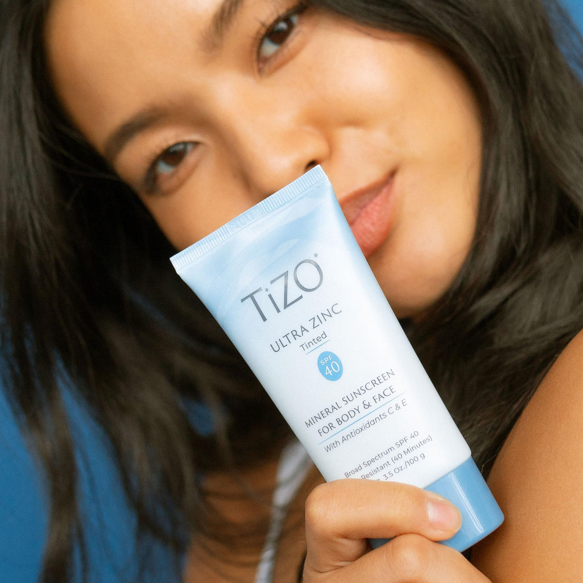 TIZO applying tinted zinc to cheek demonstrating even coverage
