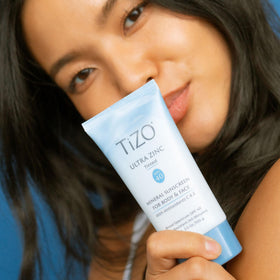 TIZO applying tinted zinc to cheek demonstrating even coverage