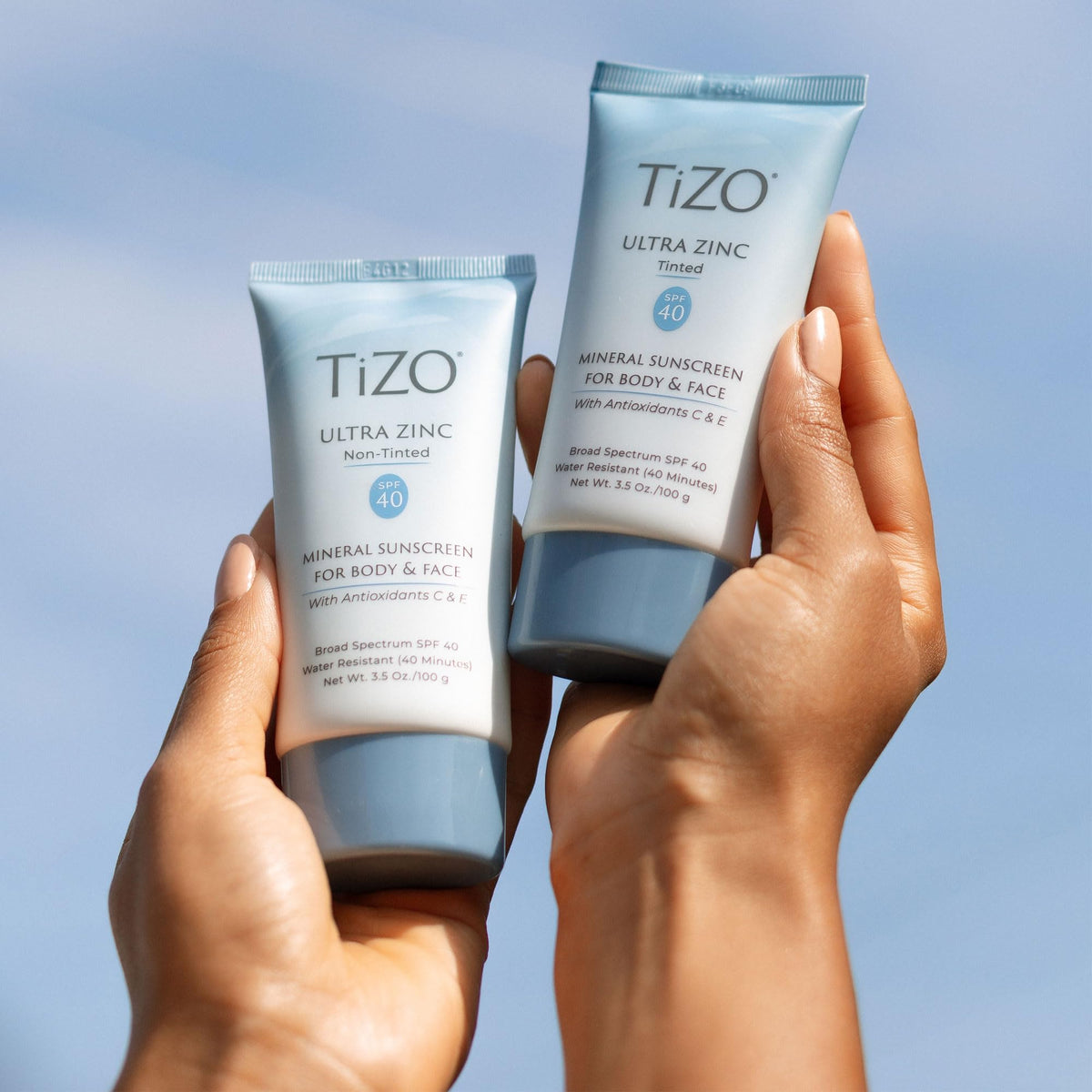Person applying TIZO outdoors illustrating broad spectrum sun defense