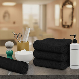 TOALLA folded towel next to hand showing size and scale