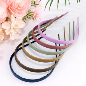 TOBATOBA headband in hand for size comparison showing compact, travel-friendly benefit