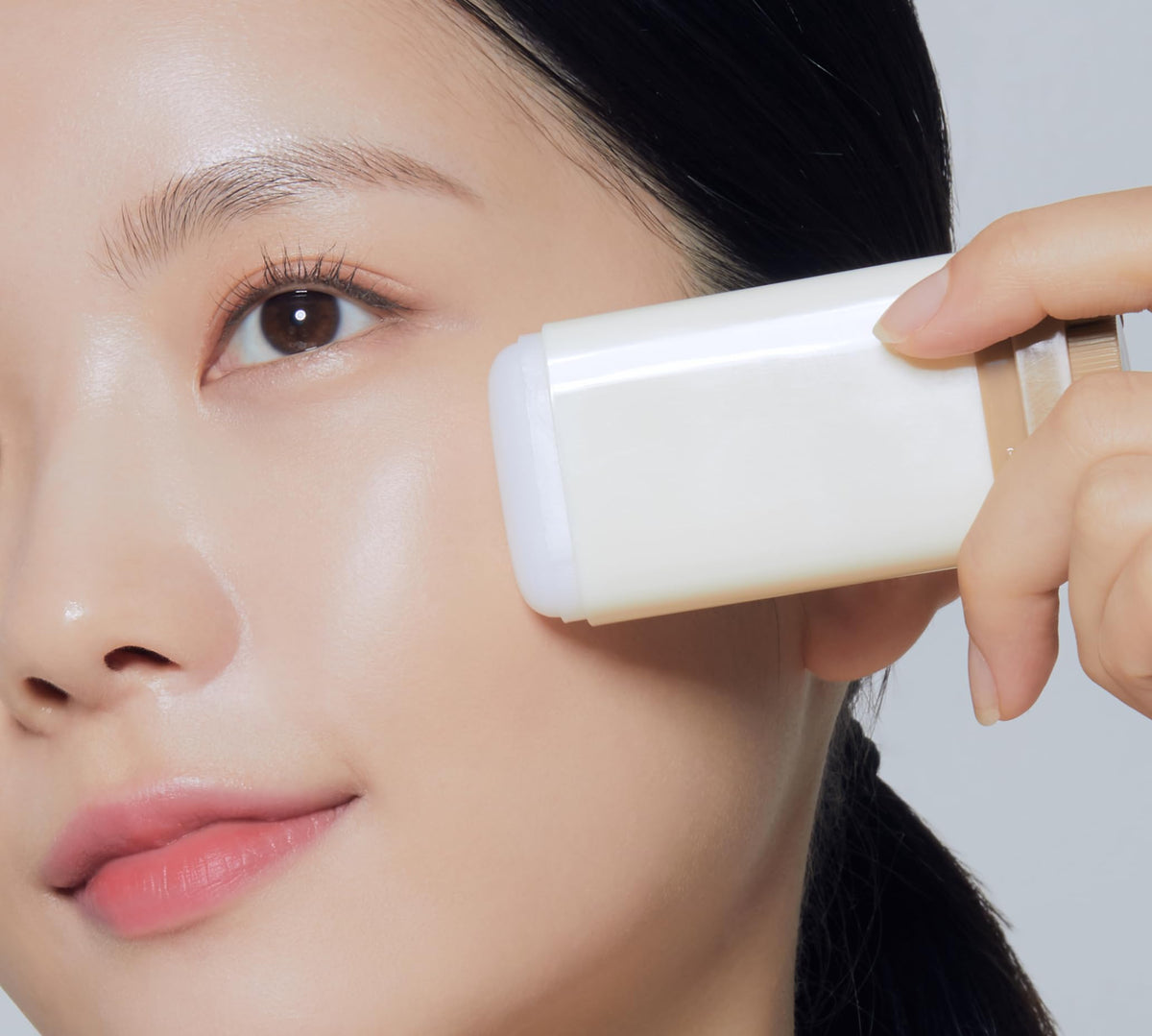 TONYMOLY 24K Snail stick application on cheek demonstrating targeted hydration benefit