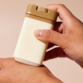 TONYMOLY 24K Snail stick in hand showing 20g scale and travel-friendly benefit