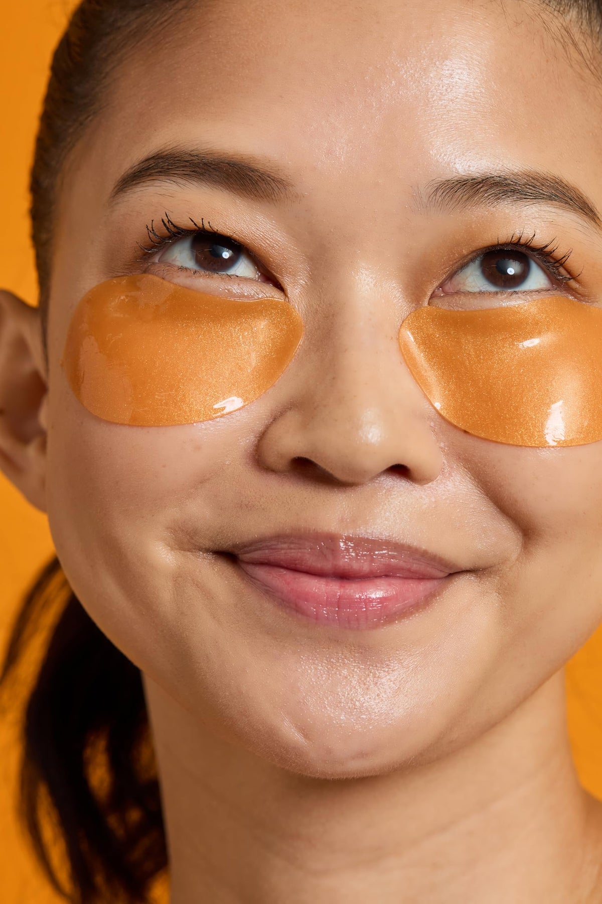 TONYMOLY patches applied under eyes demonstrating cooling effect