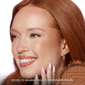 Too Faced arm swatch demonstrating buildable bronze and natural warmth