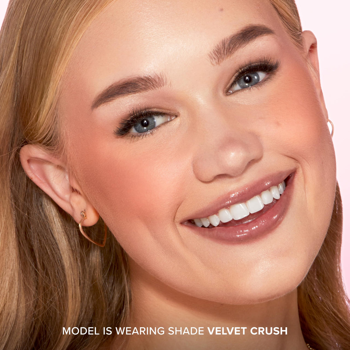 Too Faced brush applying blush to cheeks showing easy blending and wearable intensity