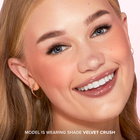 Too Faced brush applying blush to cheeks showing easy blending and wearable intensity